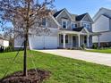 Two-story home with gray siding, white trim, and a covered front porch at 330 Cavin Dr, Roswell, GA 30076