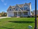 Two-story home with gray siding, white trim, and a covered front porch at 330 Cavin Dr, Roswell, GA 30076