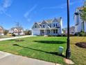 Two-story house on a tree-lined street with a large front yard at 330 Cavin Dr, Roswell, GA 30076