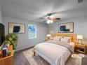 Staged bedroom with neutral decor, ceiling fan, and large window at 118 Mann Blvd, Stockbridge, GA 30281