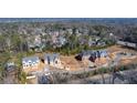 Aerial view showcasing the neighborhood, nearby properties, landscaping, and road access at 225 River Valley Lot 5 Ct, Atlanta, GA 30328