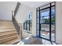Bright entryway featuring an elegant staircase and large windows providing ample natural light at 225 River Valley Lot 5 Ct, Atlanta, GA 30328