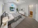 A serene bedroom with a large window and ensuite bathroom access at 2708 Parkway Trl, Lithonia, GA 30058