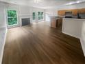 Open concept living area with hardwood floors, fireplace, and ample natural light at 2708 Parkway Trl, Lithonia, GA 30058