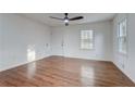 Bright, open living room with hardwood floors and ample natural light streaming through large windows at 3159 Nursery Se Rd, Smyrna, GA 30082