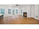 Bright living room with wood floors, a fireplace, and a kitchen view at 522 Pierce Nw Ave, Atlanta, GA 30318