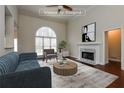 Bright living room with fireplace, vaulted ceiling, and a large window at 5055 Hickory Hills Dr, Woodstock, GA 30188