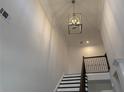 Dramatic two-story foyer with custom pendant lighting illuminating the staircase and landing at 1114 Low Water Crossing, Acworth, GA 30101