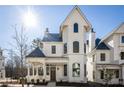 Front view of a charming white two-story house with a gray roof at 11530 Serenbe Ln, Chattahoochee Hills, GA 30268