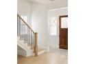 Bright entryway with a wood door, black and white tile floor, staircase and light wood floors at 11536 Serenbe Ln, Chattahoochee Hills, GA 30268