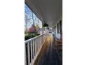 Long covered porch with a rocking chair and a view of the yard at 57 Glenn Eagles Way, Hiram, GA 30141