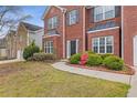 Brick two-story house with a two-car garage and landscaping at 1123 Diamond Xing, Mcdonough, GA 30252