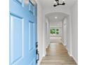 Inviting entryway with light blue front door, light walls, and hardwood floors throughout at 128 Laurel Farms Ln, Dallas, GA 30157