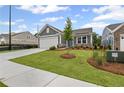 Attractive home featuring a manicured lawn, grey siding, and a two-car garage at 128 Laurel Farms Ln, Dallas, GA 30157