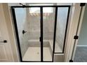 New shower with glass doors, a built-in seat, and grey tile at 128 Laurel Farms Ln, Dallas, GA 30157