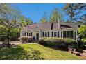 Inviting home showcasing a lush green lawn, blossoming foliage and a quaint screened porch perfect for relaxing at 111 Mount Vernon Dr, Decatur, GA 30030