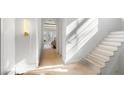 Light-filled hallway with hardwood floors and staircase leading upstairs at 1026 Reeder Cir, Atlanta, GA 30306