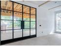 Room with black framed glass doors opening to backyard at 1026 Reeder Cir, Atlanta, GA 30306