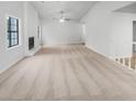Bright and open living room featuring neutral carpet and a white-painted fireplace at 2713 Laurel View Dr, Snellville, GA 30039