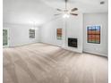 Spacious living room with a fireplace, ceiling fan, and large windows for ample natural light at 2713 Laurel View Dr, Snellville, GA 30039