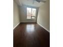 Bedroom featuring hardwood floors, large windows, and neutral paint for a comfortable living space at 171 Auburn Ave # 329, Atlanta, GA 30303