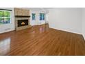 Bright living room featuring hardwood floors and a classic stone fireplace at 3371 Vandiver Dr, Marietta, GA 30066