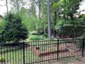 Fenced-in backyard with garden bed surrounded by large mature trees at 5741 Wolf Laurel, Lilburn, GA 30047