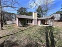 Back exterior view with covered porch and lush lawn, perfect for outdoor enjoyment at 5947 Rock Rd, Union City, GA 30291
