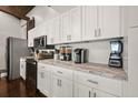 Bright kitchen with white cabinetry, stainless steel appliances, and granite counters at 7 Yachting Way, Acworth, GA 30102