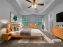Serene primary bedroom with tray ceilings, carpet, and ample natural light at 3542 Broad Oak Ct, Decatur, GA 30034