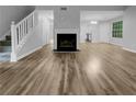 Open concept living room featuring hardwood floors, a cozy fireplace, and neutral color palette at 3542 Broad Oak Ct, Decatur, GA 30034