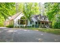 Inviting home with a long driveway and lots of surrounding trees at 465 Se Willowbrook Se Dr, Smyrna, GA 30082