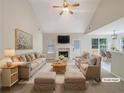 Bright and airy living room featuring vaulted ceilings, a fireplace, and modern decor at 402 Lafayette St, Dallas, GA 30157
