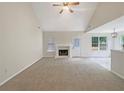 Spacious living room with a fireplace, vaulted ceiling, and view to the dining area at 402 Lafayette St, Dallas, GA 30157