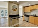 Modern kitchen with light wood cabinets, stainless steel appliances, and a breakfast bar at 385 Ralph Mcgill Ne Blvd # Q, Atlanta, GA 30312