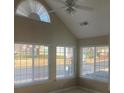 Bright living room with large windows, ceiling fan, and neutral paint, showcasing natural light at 6133 Malloway Ct, Cumming, GA 30041