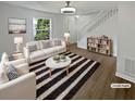 Bright living room featuring neutral tones, hardwood floors, and a staircase leading to the upper level at 806 Brighton Pt, Atlanta, GA 30328
