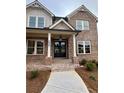 Brick home with a covered front porch and double doors at 4125 Sierra Vista Cir, Cumming, GA 30040