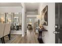 Inviting foyer featuring hardwood floors, elegant decor, and seamless transition to dining and living areas at 558 Abbott Se Ct, Atlanta, GA 30354