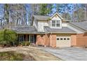 Charming home featuring a brick facade, attached garage, and meticulously landscaped front yard at 6 Dover Trl, Peachtree City, GA 30269