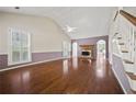 Spacious living room with high ceilings, fireplace, hardwood floors, and arched doorways at 6 Dover Trl, Peachtree City, GA 30269