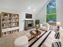 Bright living room featuring a stone fireplace, large windows and neutral decor creating a comfortable atmosphere at 3213 Cedar Bluff Ne Dr, Marietta, GA 30062