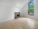 Bright living room featuring a stone fireplace and large window creating a comfortable atmosphere at 3213 Cedar Bluff Ne Dr, Marietta, GA 30062