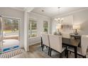 Bright dining room with a table and chairs, hardwood floors, and a chandelier at 565 Abbott Se Ct, Atlanta, GA 30354