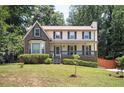 Two-story brick home with covered porch and landscaped yard at 3664 Nessa Se Ct, Smyrna, GA 30082