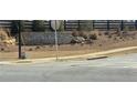 Stone Highland Park sign with landscaped plants and a black wooden fence at 6038 Spring Way, Stonecrest, GA 30038