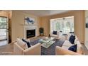 Cozy living room featuring a fireplace, plush seating, and large windows for natural light at 102 Gettysburg Pl, Sandy Springs, GA 30350