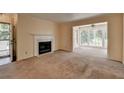 Bright living room featuring a fireplace, bay window, and carpet flooring at 102 Gettysburg Pl, Sandy Springs, GA 30350