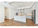 Modern kitchen features an island, stainless steel appliances, and ample cabinet space at 5245 Maggie Mae Ln, Cumming, GA 30028