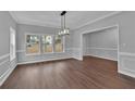 Bright dining room with three large windows and hardwood floors at 250 Stonecreek Pkwy, Covington, GA 30016